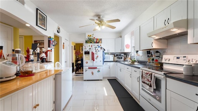 kitchen featuring a textured ceiling, white appliances, and white cabinetry