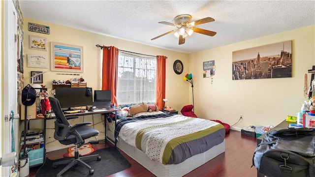 bedroom featuring ceiling fan, dark hardwood / wood-style floors, and a textured ceiling