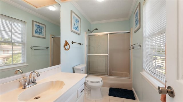 full bathroom with tile patterned flooring, enclosed tub / shower combo, toilet, ornamental molding, and vanity