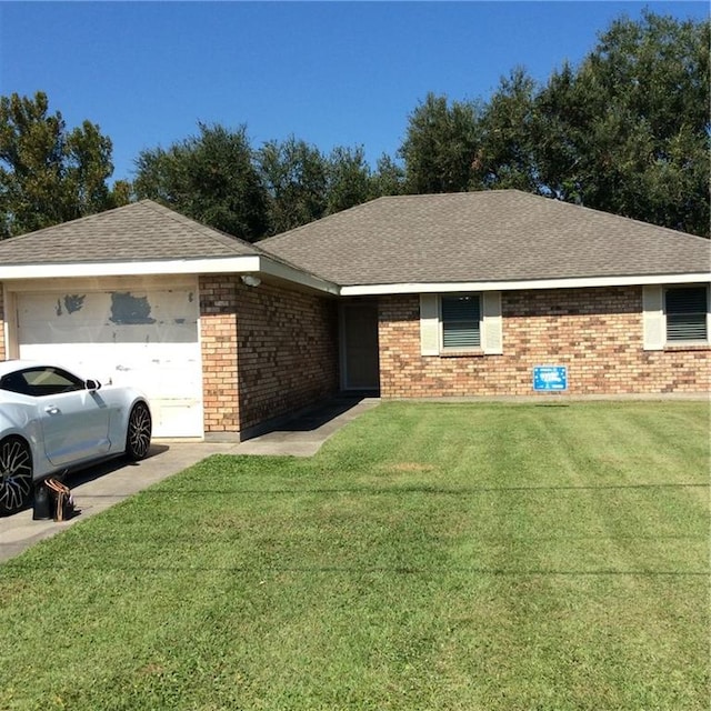 ranch-style house featuring a garage and a front yard