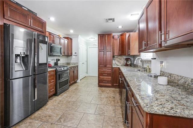 170 Becs Pl, Braithwaite, LA 70040 - kitchen featuring light stone countertops, recessed lighting, appliances with stainless steel finishes, a sink, and visible vents