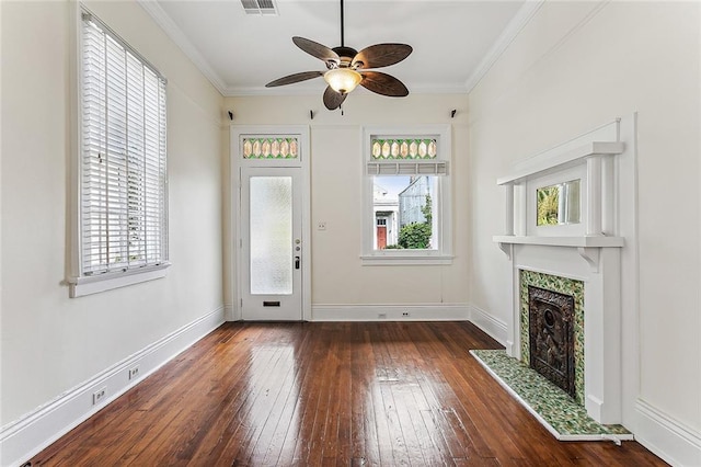 unfurnished living room with ceiling fan, dark hardwood / wood-style floors, and a wealth of natural light