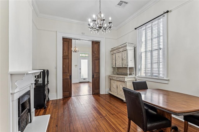 office space featuring ornamental molding, a wealth of natural light, dark wood-type flooring, and a chandelier