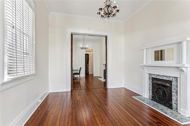 unfurnished living room with an inviting chandelier, crown molding, and dark wood-type flooring