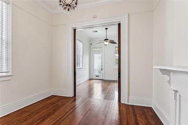 foyer with ceiling fan with notable chandelier, crown molding, dark wood-type flooring, and a wealth of natural light