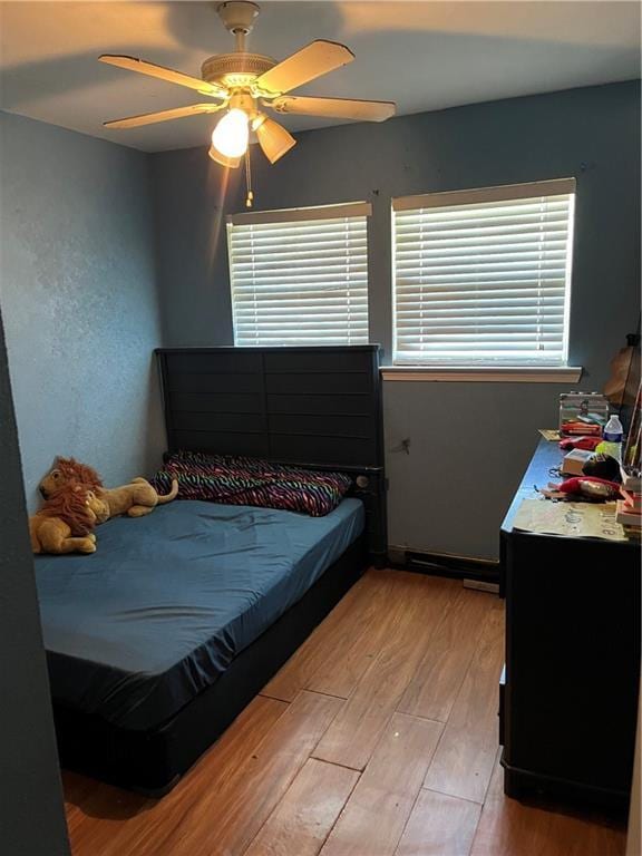 bedroom with light wood-type flooring and ceiling fan