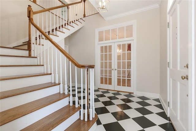 entryway featuring crown molding and french doors