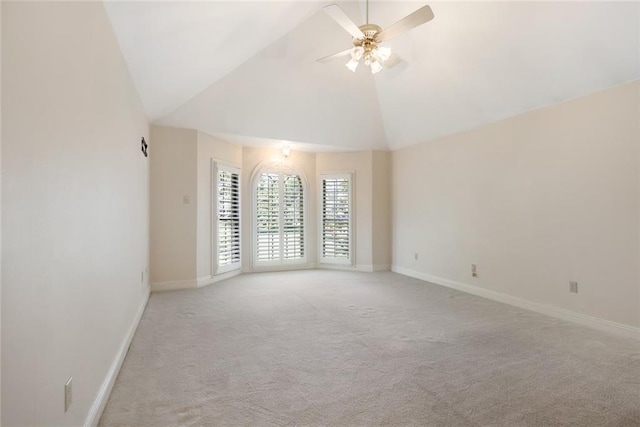 unfurnished room with light carpet, high vaulted ceiling, and ceiling fan