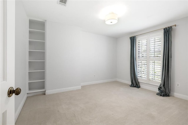 unfurnished room with light carpet