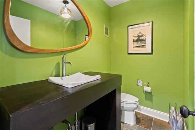 bathroom with vanity and toilet