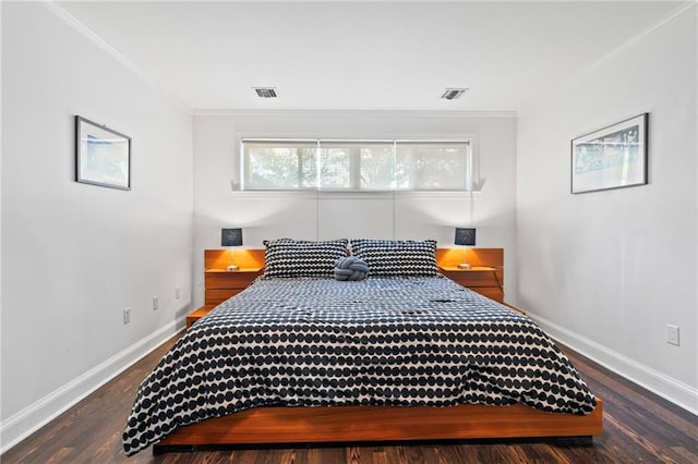 bedroom featuring dark wood-type flooring and crown molding