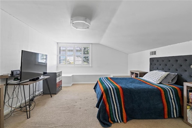 bedroom featuring light carpet and vaulted ceiling