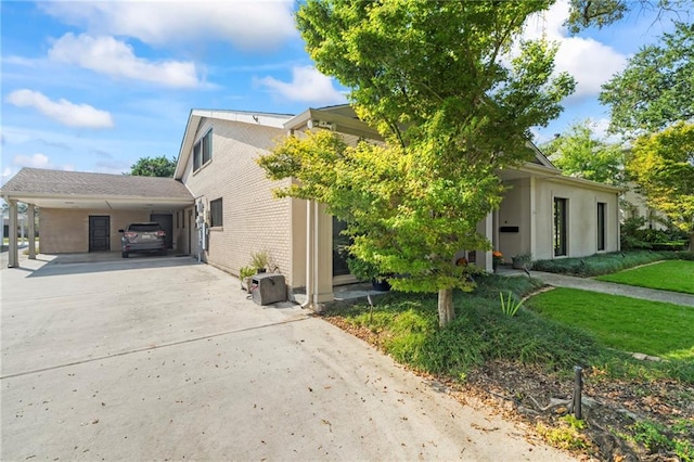 view of property exterior featuring a yard and a carport