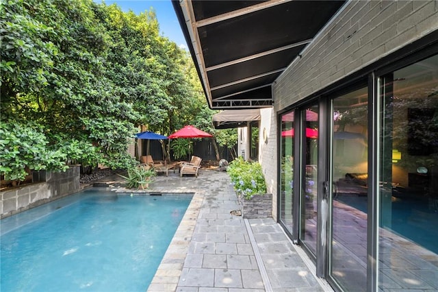 view of swimming pool featuring a patio area