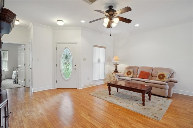 living room with ceiling fan, light hardwood / wood-style flooring, and ornamental molding