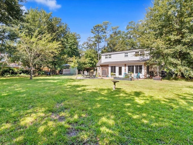 641 Adair St, Mandeville, LA 70448 - rear view of property with a sunroom and a yard