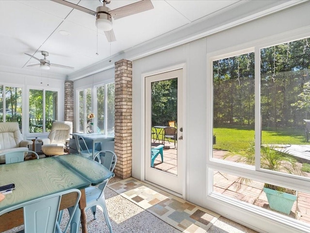 sunroom featuring a healthy amount of sunlight and ceiling fan