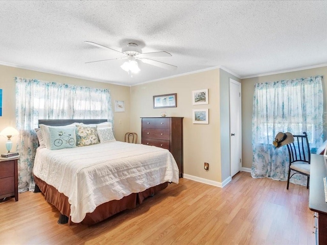 bedroom with light wood-type flooring, crown molding, ceiling fan, and a textured ceiling