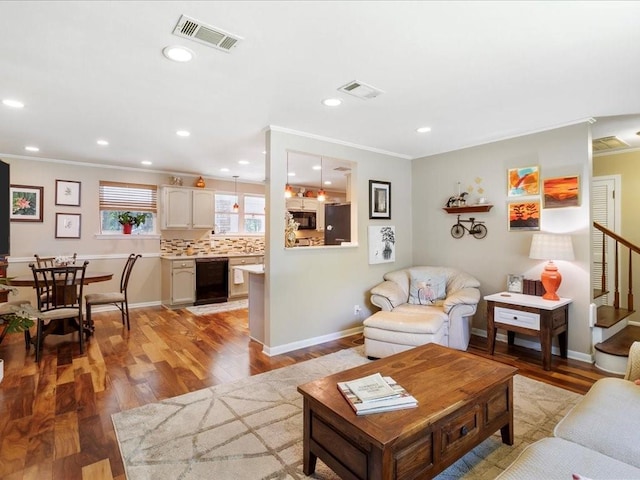 641 Adair St, Mandeville, LA 70448 - living room with ornamental molding, light wood-style flooring, stairway, recessed lighting, and baseboards
