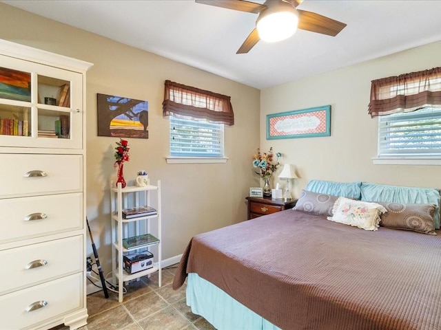 bedroom with multiple windows and ceiling fan