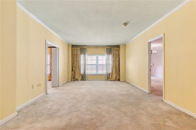 spare room with ornamental molding and light carpet