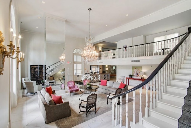 living room with light tile patterned floors, crown molding, a towering ceiling, and a chandelier