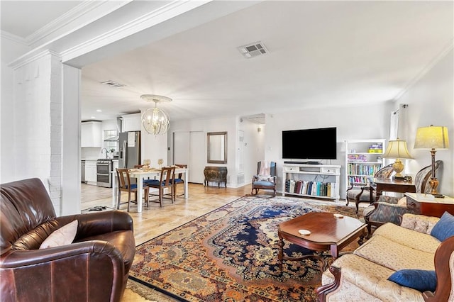 living room with ornamental molding and an inviting chandelier