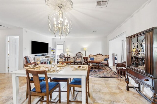 dining area with ornamental molding and a notable chandelier