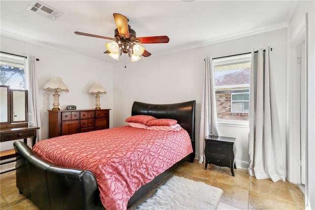 bedroom with ornamental molding and ceiling fan