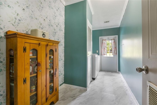 doorway with separate washer and dryer and crown molding