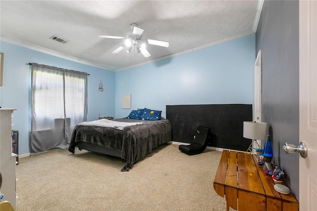 bedroom featuring ceiling fan, carpet floors, ornamental molding, and a textured ceiling