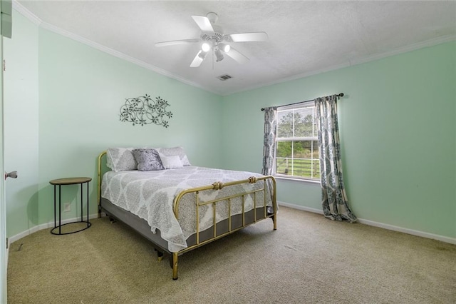 carpeted bedroom featuring ceiling fan and crown molding