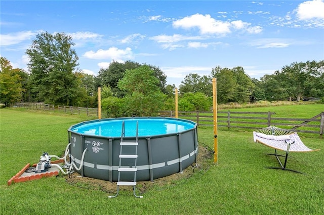 view of pool with a lawn