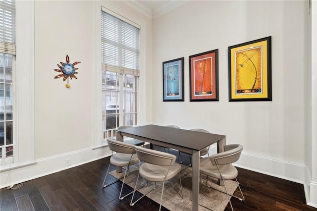 dining area with dark wood-type flooring and ornamental molding