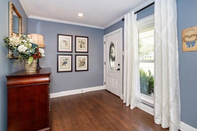 entryway featuring ornamental molding, dark wood finished floors, and baseboards