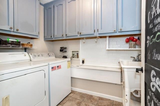 laundry room featuring cabinet space, independent washer and dryer, a sink, and light tile patterned flooring