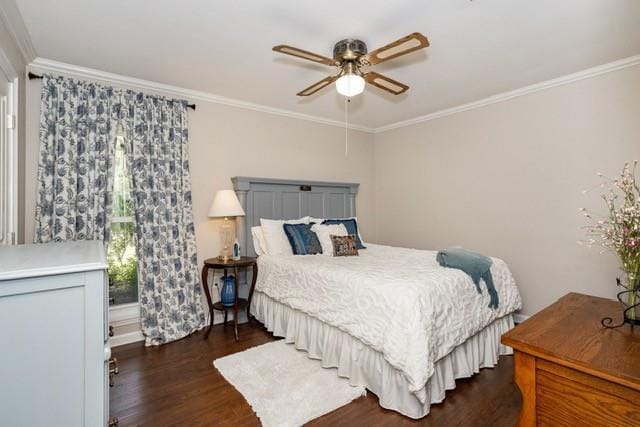 bedroom featuring ornamental molding, dark wood-style flooring, and a ceiling fan