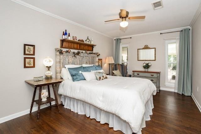 bedroom with ornamental molding, dark wood finished floors, visible vents, and baseboards