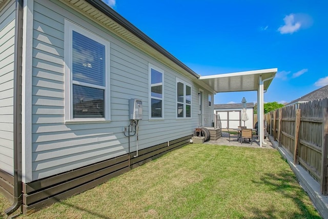 back of property with a lawn and a patio area