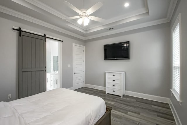 bedroom with multiple windows, ceiling fan, a barn door, and dark hardwood / wood-style floors