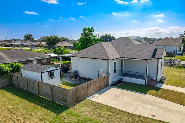 rear view of house with a yard and a patio area