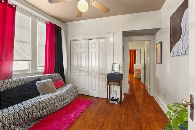 sitting room featuring ornamental molding, dark hardwood / wood-style floors, and ceiling fan