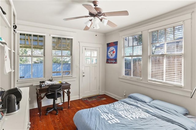 bedroom featuring multiple windows, dark hardwood / wood-style floors, and ceiling fan