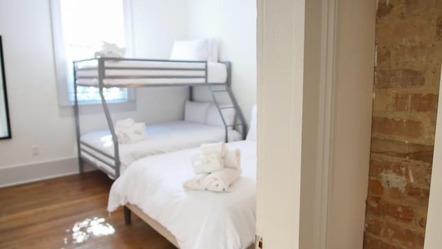 bedroom featuring hardwood / wood-style flooring and multiple windows