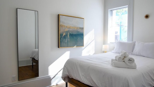 bedroom with wood-type flooring