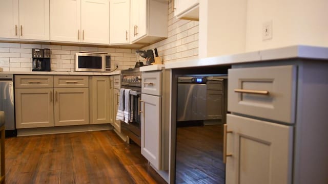 kitchen with tasteful backsplash, dark hardwood / wood-style floors, and white cabinetry