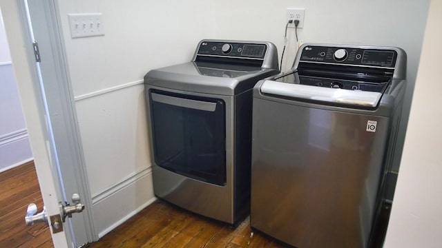 laundry area featuring washer and dryer and dark hardwood / wood-style floors