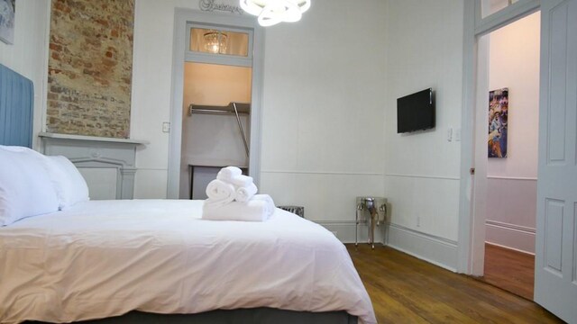 bedroom featuring a closet, dark hardwood / wood-style flooring, and a spacious closet