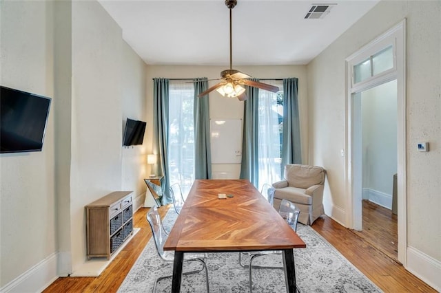 dining room featuring light hardwood / wood-style floors and ceiling fan