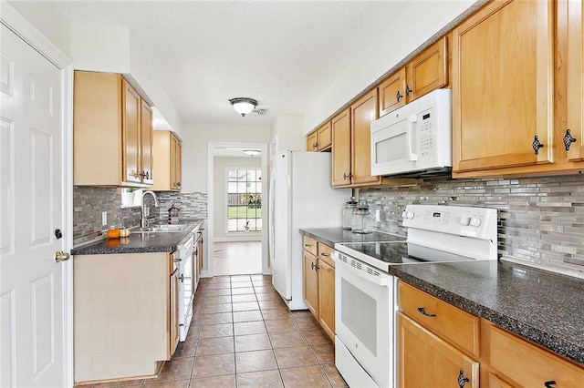 kitchen with white appliances, light tile patterned floors, sink, and backsplash